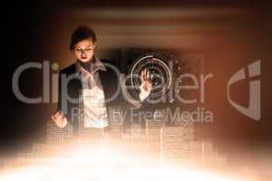 Composite image of redhead businesswoman using interactive desk