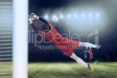 Composite image of goalkeeper in red jumping up