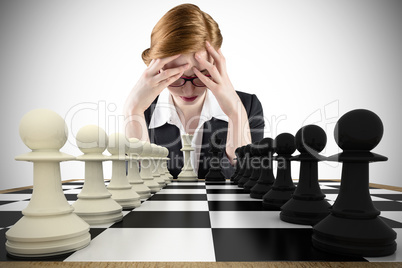 Composite image of redhead businesswoman with head in hands