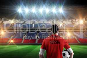 Composite image of russia football player holding ball