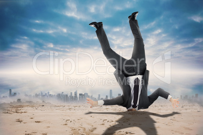 Composite image of businessman burying his head