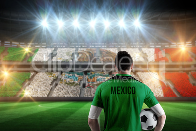 Composite image of mexico football player holding ball