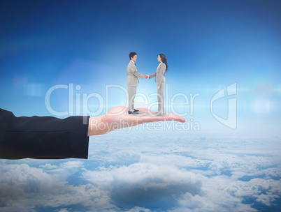 Composite image of side view of hand shaking trading partners