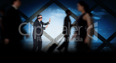 Composite image of mature businessman in a blindfold