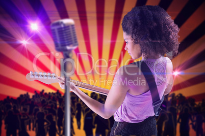 Composite image of pretty girl playing guitar