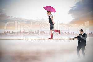 Young businessman pulling a tightrope for businesswoman