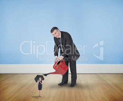 Composite image of mature businessman watering tiny businesswoma