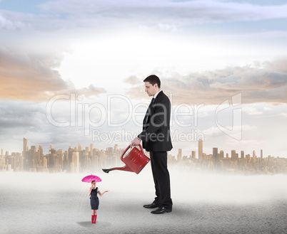 Composite image of businessman watering tiny businesswoman Composite image of businessman watering tiny businesswoman