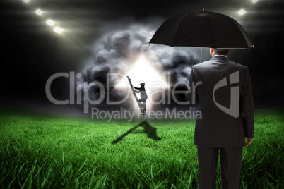 Composite image of businessman climbing up ladder