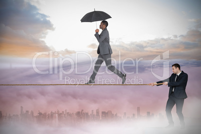 Young businessman pulling a tightrope for business man