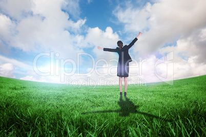 Composite image of excited businesswoman cheering