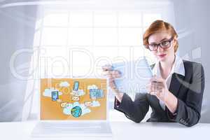 Composite image of redhead businesswoman using her tablet pc