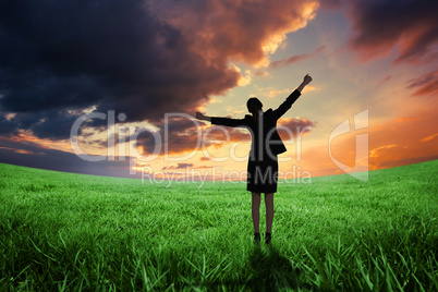 Composite image of excited businesswoman cheering