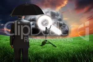 Composite image of mature businessman holding an umbrella