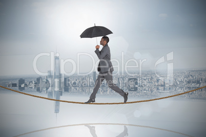 Composite image of businessman walking and holding umbrella on t Composite image of businessman walking and holding umbrella on t