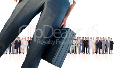 Composite image of businessman holding briefcase