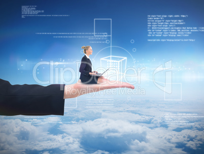 Composite image of businesswoman using laptop