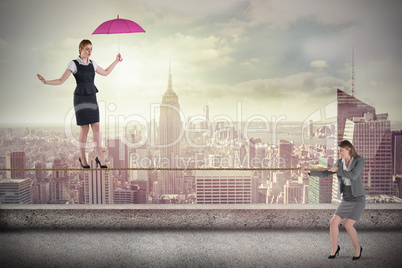 Young businesswoman pulling a tightrope for business woman