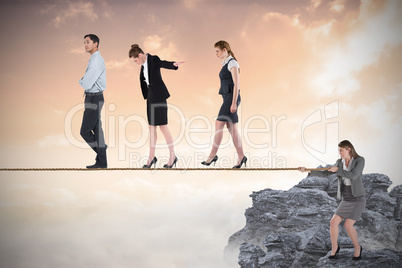 Young businesswoman pulling a tightrope for business people