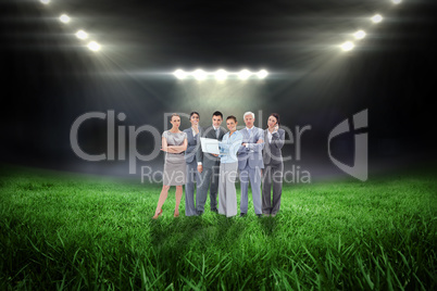 Composite image of business team looking at camera