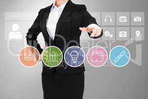 Businesswoman in suit pointing finger at business app buttons