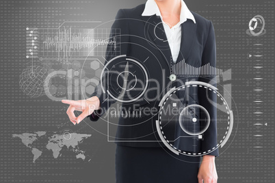 Composite image of businesswoman pointing at interface