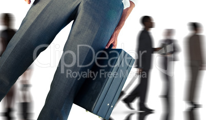 Composite image of businessman holding briefcase