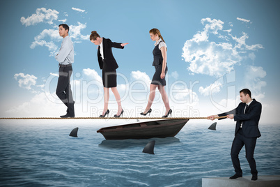 Young businessman pulling a tightrope for business people