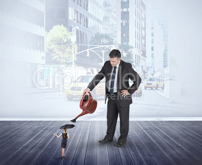 Composite image of mature businessman watering tiny businesswoma