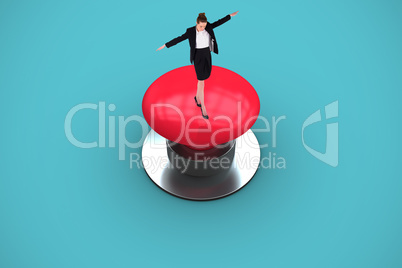 Composite image of businesswoman performing a balancing act