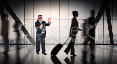 Composite image of mature businessman in a blindfold