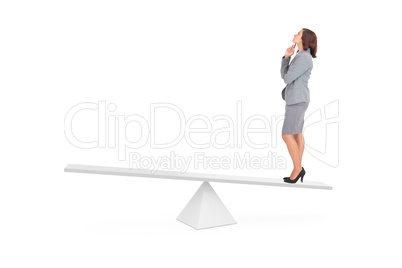 Composite image of focused businesswoman on scales