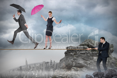 Young businessman pulling a tightrope for business people