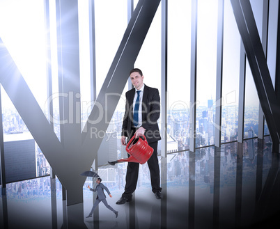 Composite image of businessman watering tiny businessman Composite image of businessman watering tiny businessman