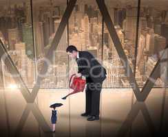 Composite image of businessman watering tiny business woman