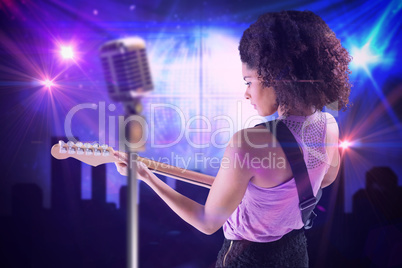 Composite image of pretty girl playing guitar