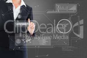 Composite image of businesswoman pointing to interface