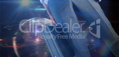 Composite image of businessman holding briefcase