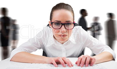 Composite image of businesswoman typing on a keyboard