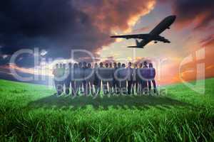 Composite image of business people standing up with airplane