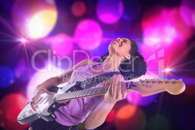 Composite image of pretty girl playing guitar