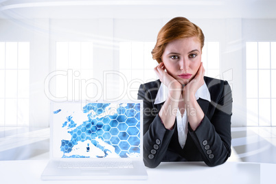 Composite image of redhead businesswoman looking unhappy Composite image of redhead businesswoman looking unhappy