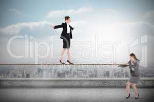 Young businesswoman pulling a tightrope for business woman