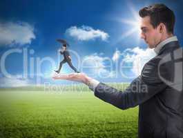 Composite image of businessman holding business man jumping