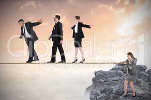 Young businesswoman pulling a tightrope for business people