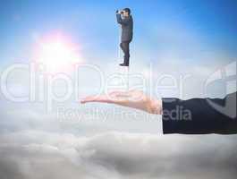 Composite image of businessman standing on ladder