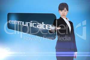 Businesswoman pointing to word communicate