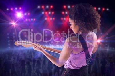 Composite image of pretty girl playing guitar