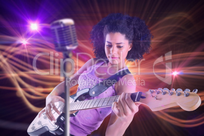 Composite image of pretty girl playing guitar