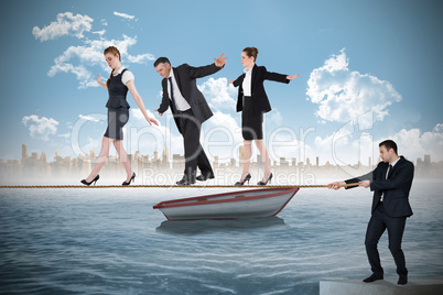 Young businessman pulling a tightrope for business people